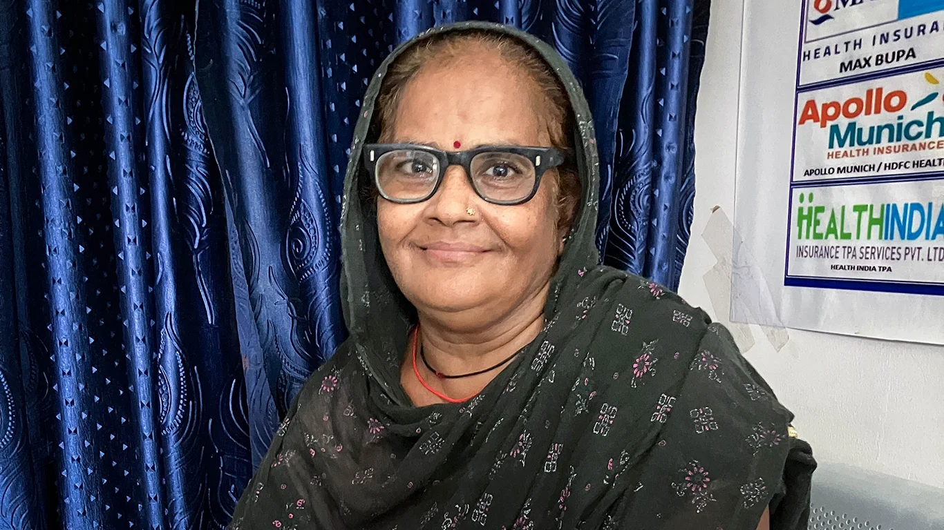 A woman sits in a clinic setting