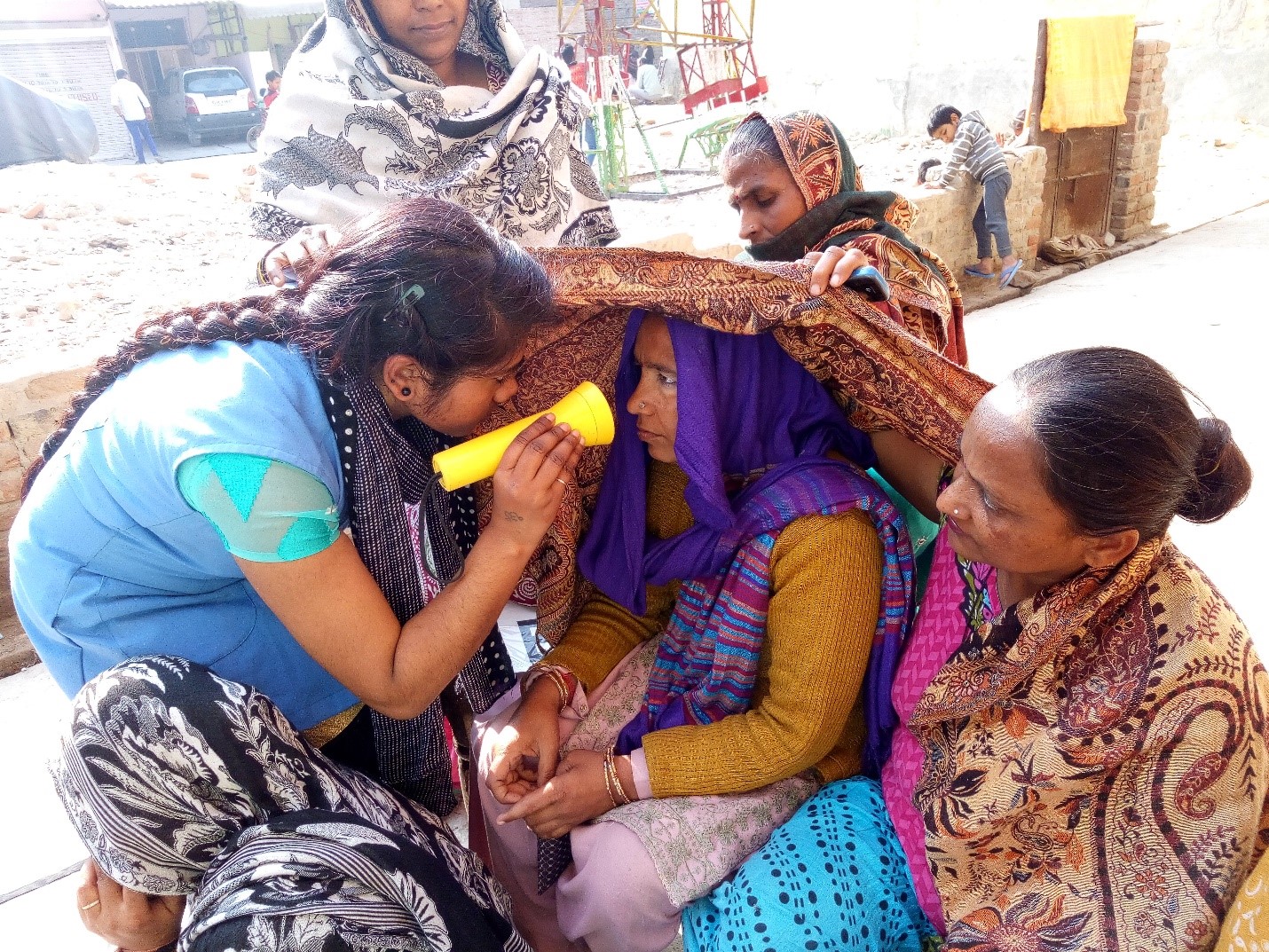 Eye screening being performed by a community health worker