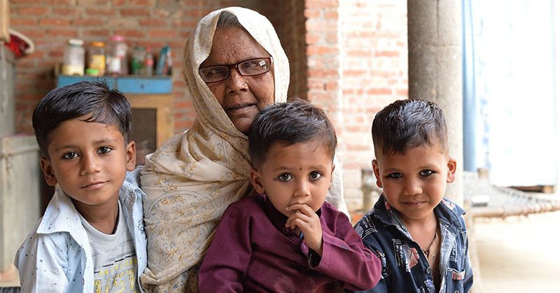Grandmother poses with three grandchildren