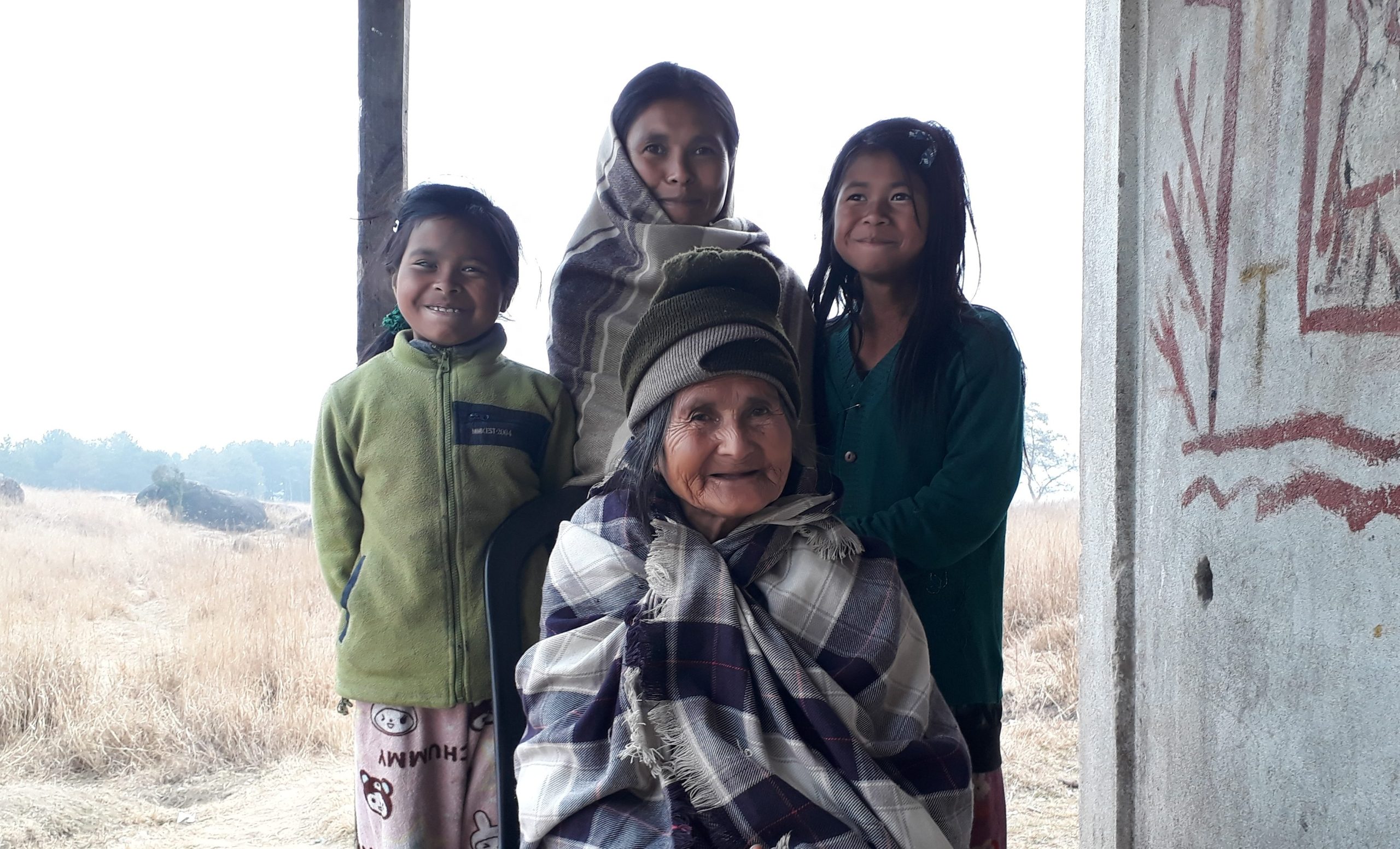 Senior woman posing with three children.