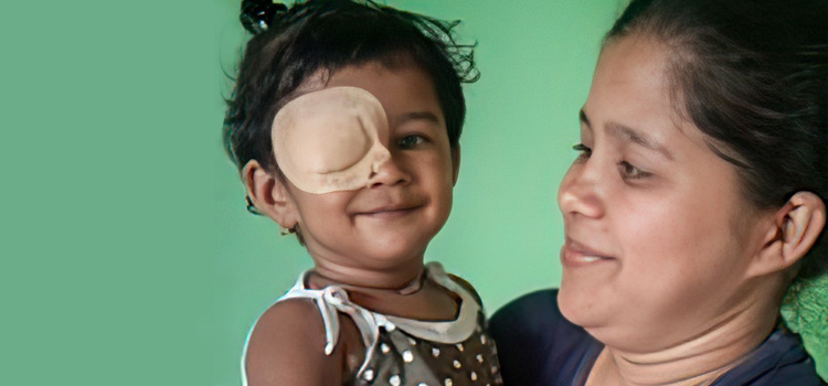 A mother smiles at her daughter who is wearing an eye patch to treat her strabismus|A smiling toddler. The little girl has a patch over her right eye.