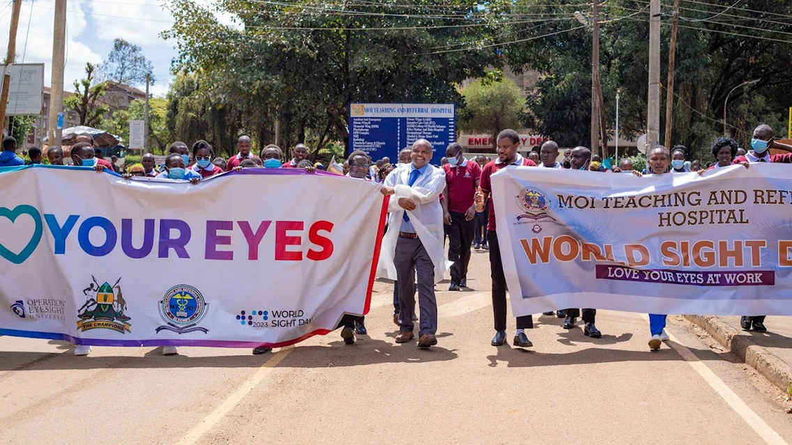 |A man holds a cardboard mascot image.