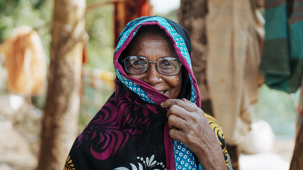 A woman wearing eyeglasses poses for a picture