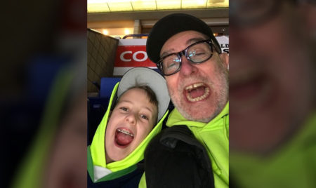 Young boy posing with his father.||