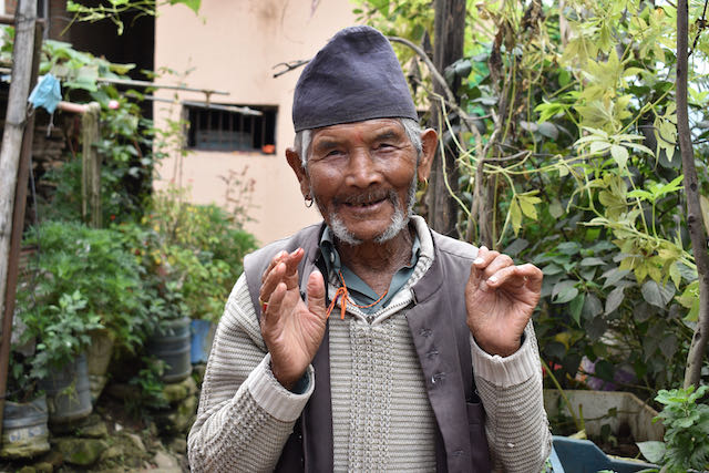 A senior man smiling at the camera|A young woman talking with a senior man|A group of people looking at the camera