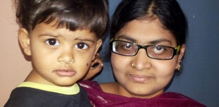 Woman carrying her son while wearing eyeglasses|Woman carrying her son while wearing eyeglasses.