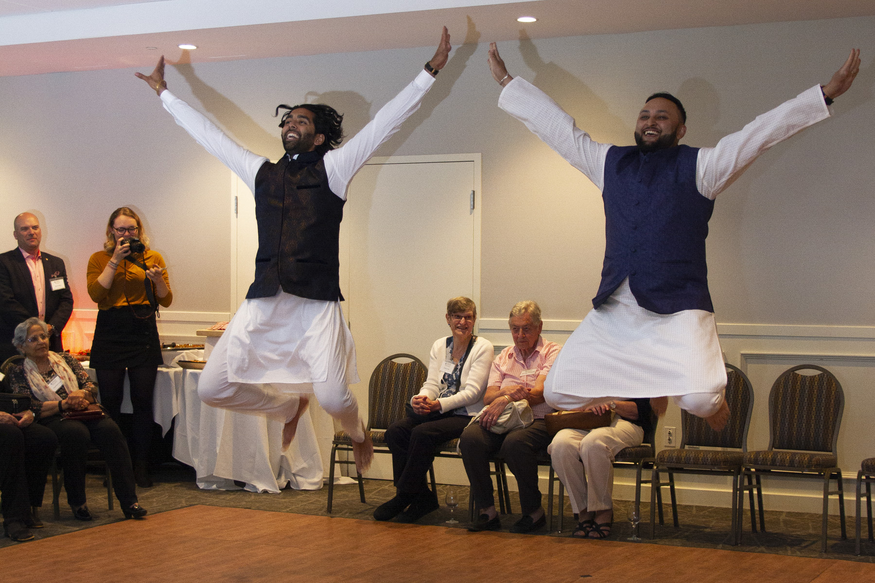 Two men dancing jumping in the air together.|Operation Eyesight Annual Report 2018 cover|Alice Mwangi