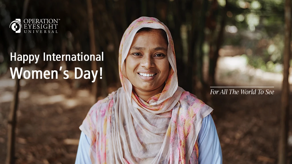 A young woman wearing a pink head scarf stands outdoors
