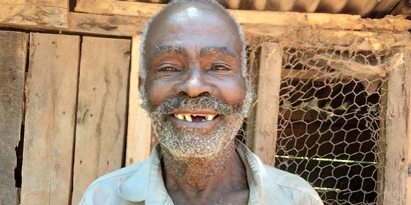 Portrait of Simon. A senior man smiling at the camera|A senior man sorts through coffee beans