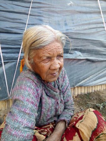 Woman sitting down.|Woman names Sita Bhandari wearing sunglasses outside.
