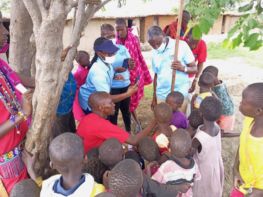 Operation Eyesight staff measures the height of children as a part of administering antibiotics to prevent trachoma|Community health volunteers takes notes as he administers antibiotics against trachoma to children|Operation Eyesight staff measures the height of children as a part of administering antibiotics to prevent trachoma|Community health volunteer administers antibiotics to children